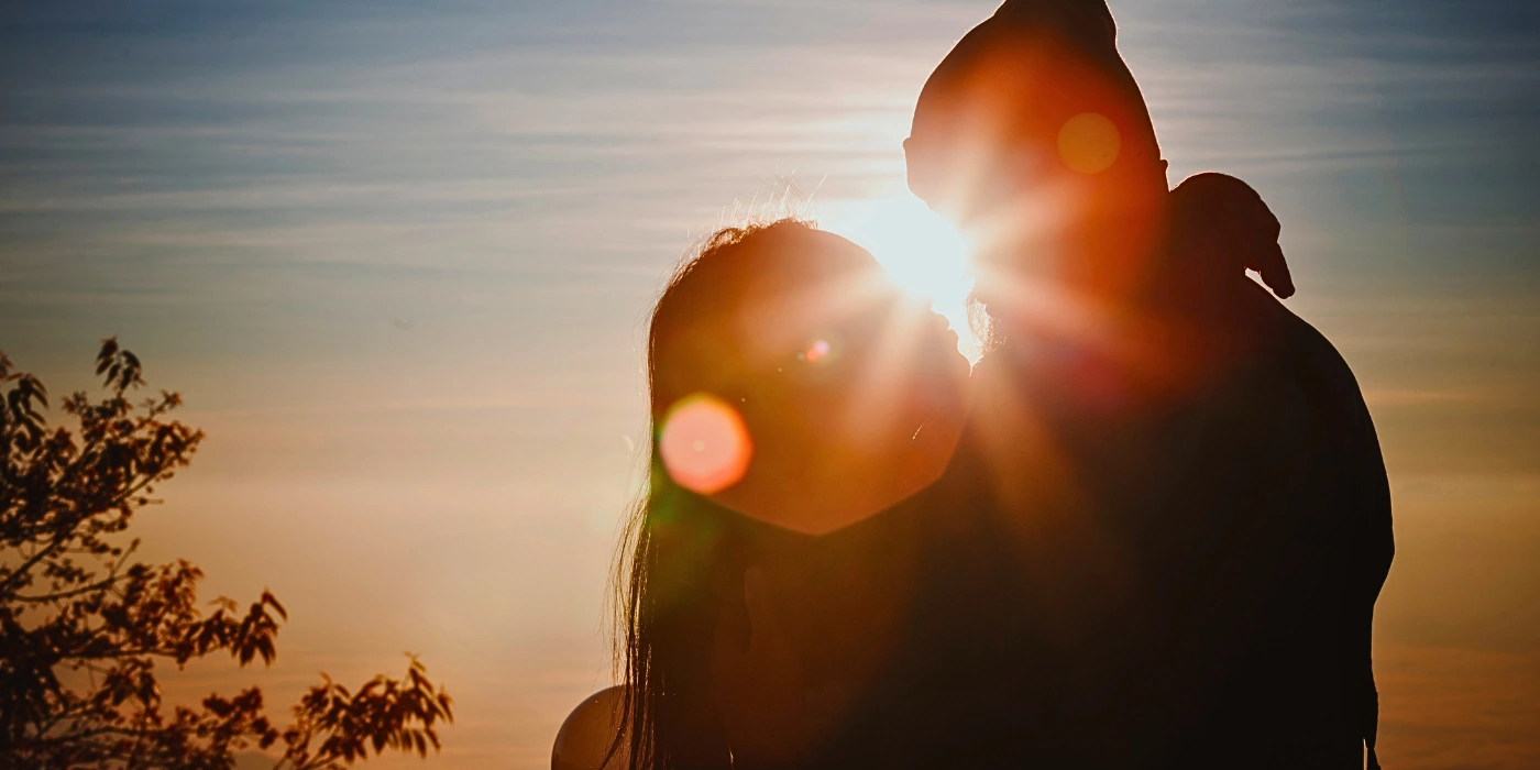 A couple going for a kiss behind the sunset in a kundasang trip of romantic things to do in kundasang