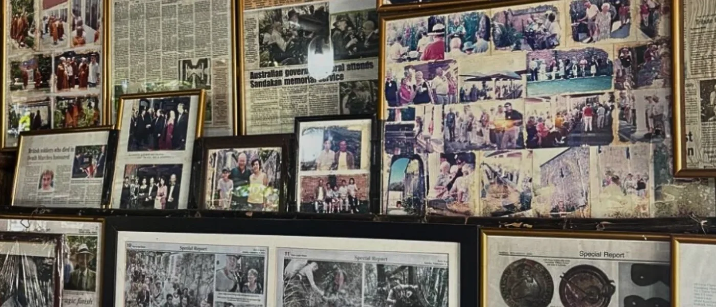 Collage display of old newspaper articles and historical records at Kundasang War Memorial