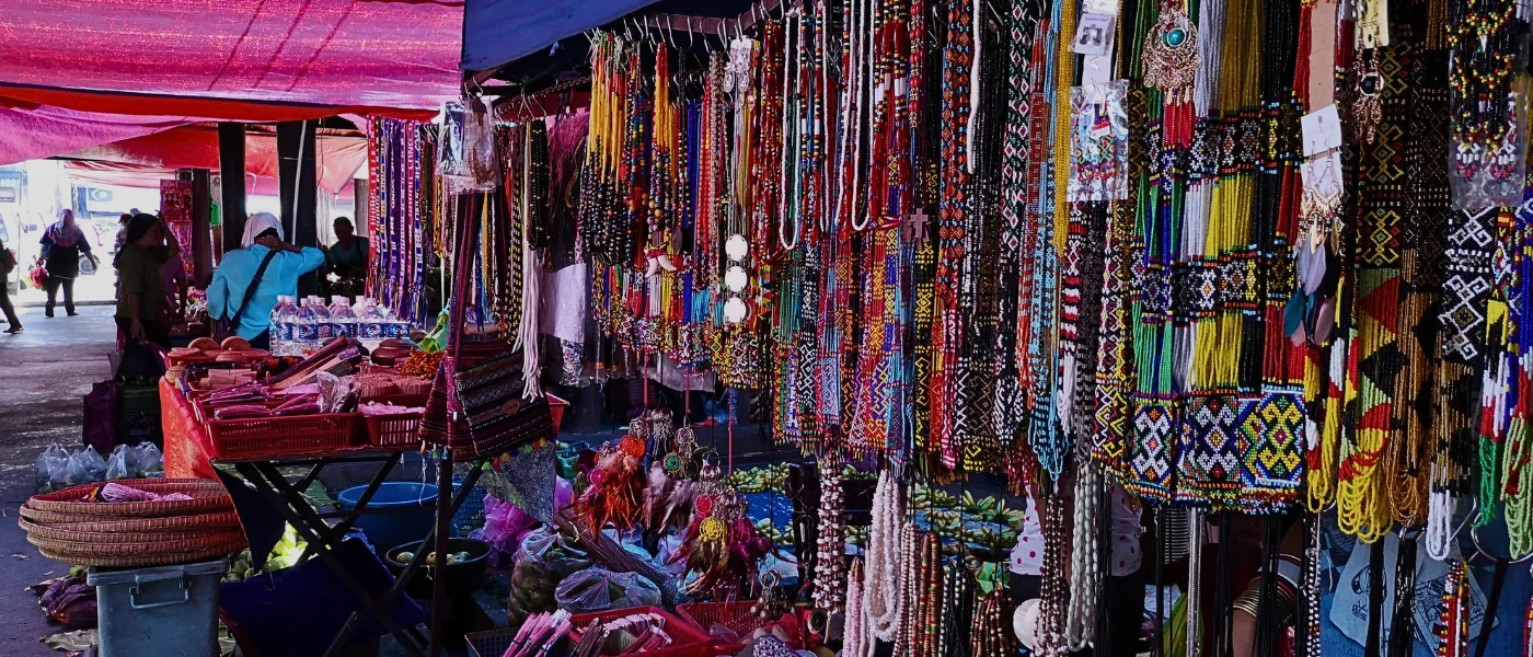 Colorful Dusun beadwork handicrafts displayed at Kundasang market stalls.