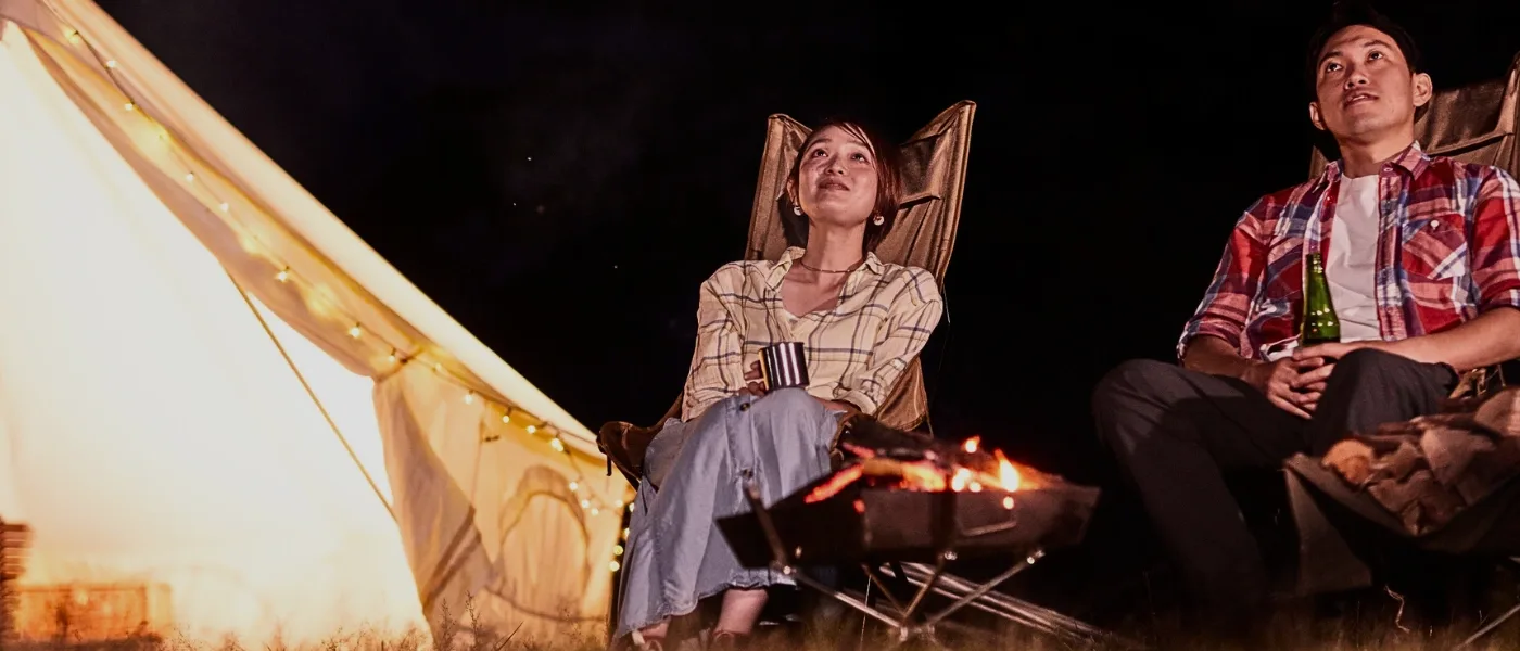 Couple stargazing under a starry night sky in Kundasang.