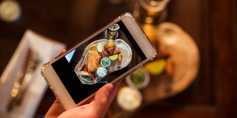 Person taking photos of food while food and shopping hunting in Kundasang