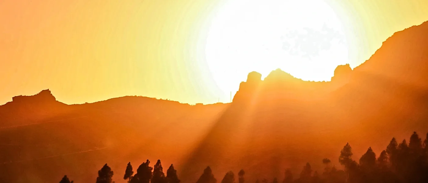 Sunrise casting golden light behind Mount Kinabalu in Sabah