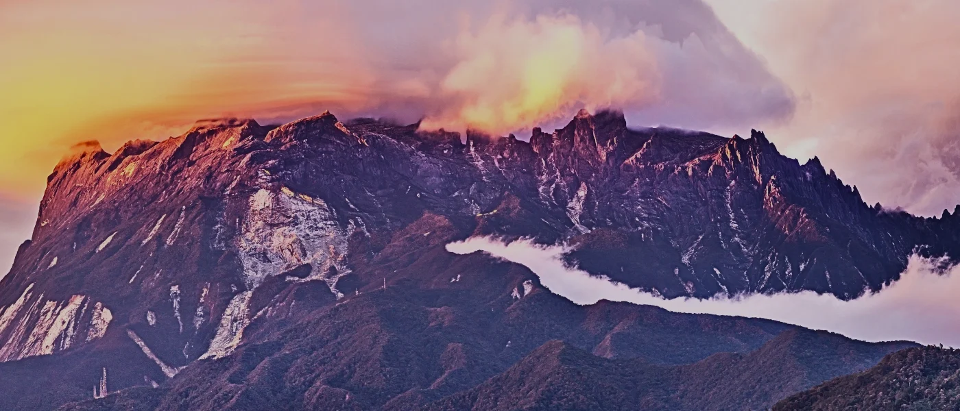 Mt Kinabalu at sunset Mount Kinabalu silhouetted against a vibrant sunset sky