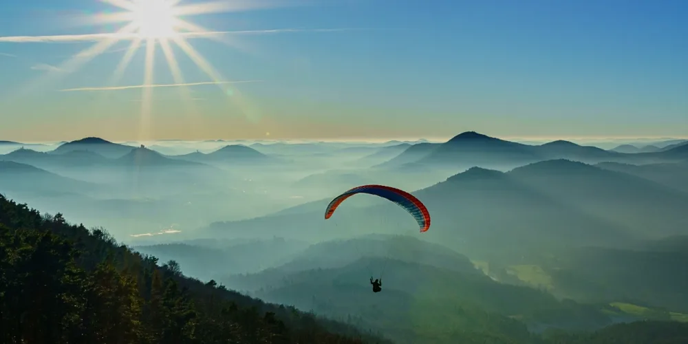 Visitors paragliding above kundasang highlights as part of our tour package for adventure activities in kundasang