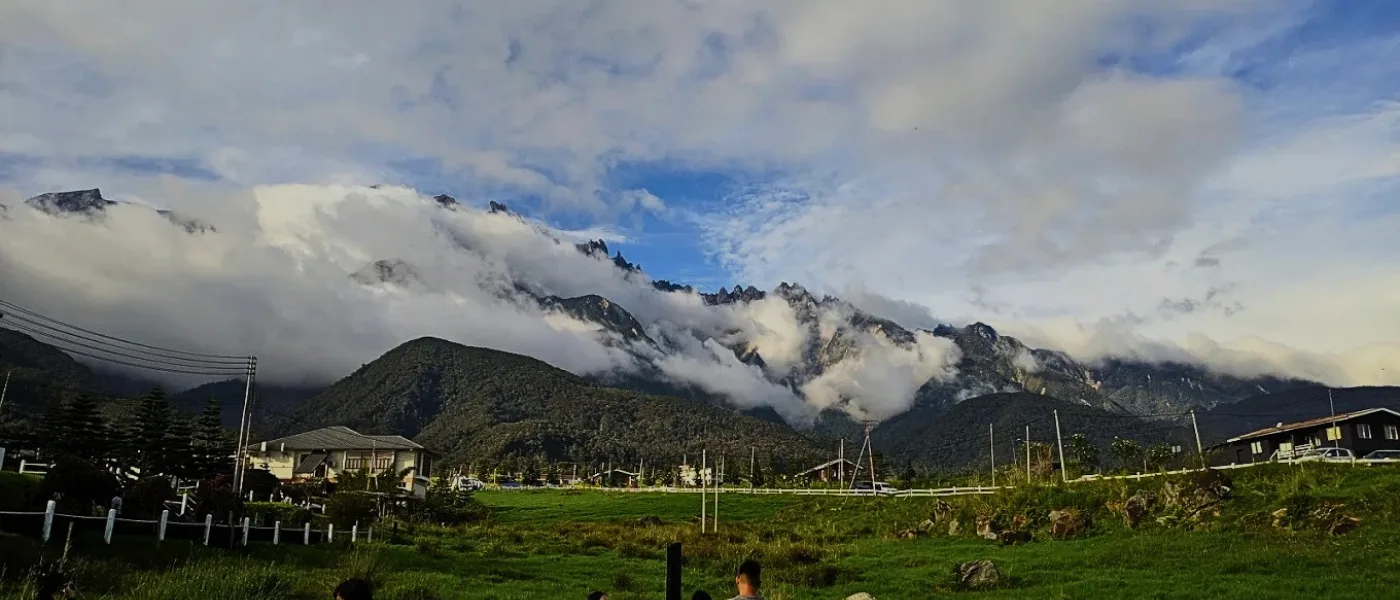 Scenic view of Mount Kinabalu partly covered by clouds, seen from Desa Dairy Farm Kundasang