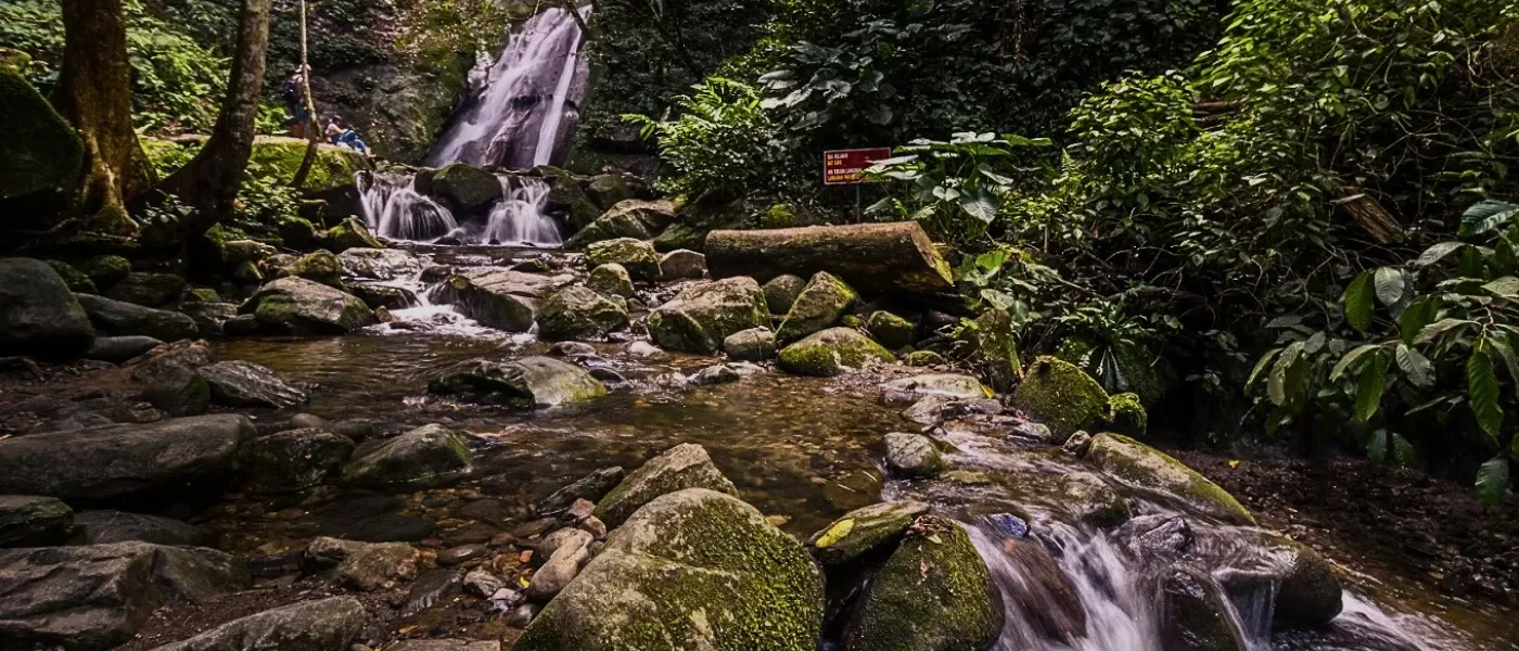 Kipungit Waterfall in Poring, surrounded by lush greenery