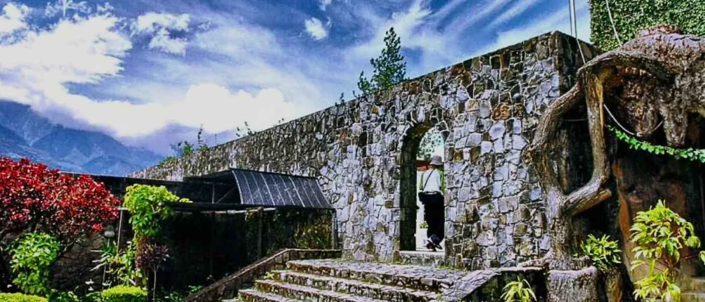 Stone walls and entrance pathway at Kundasang War Memorial with gardens