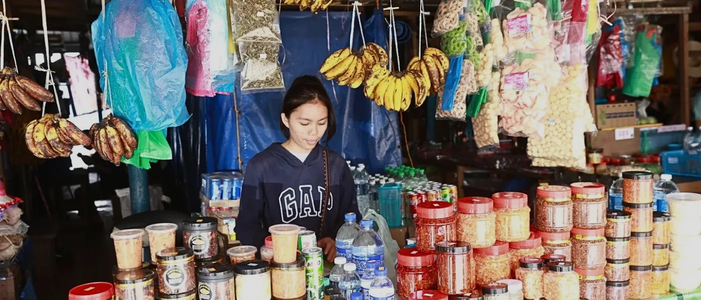 Vendor selling assorted preserved foods, jams, and local delicacies at Pekan Nabalu Market in Kundasang