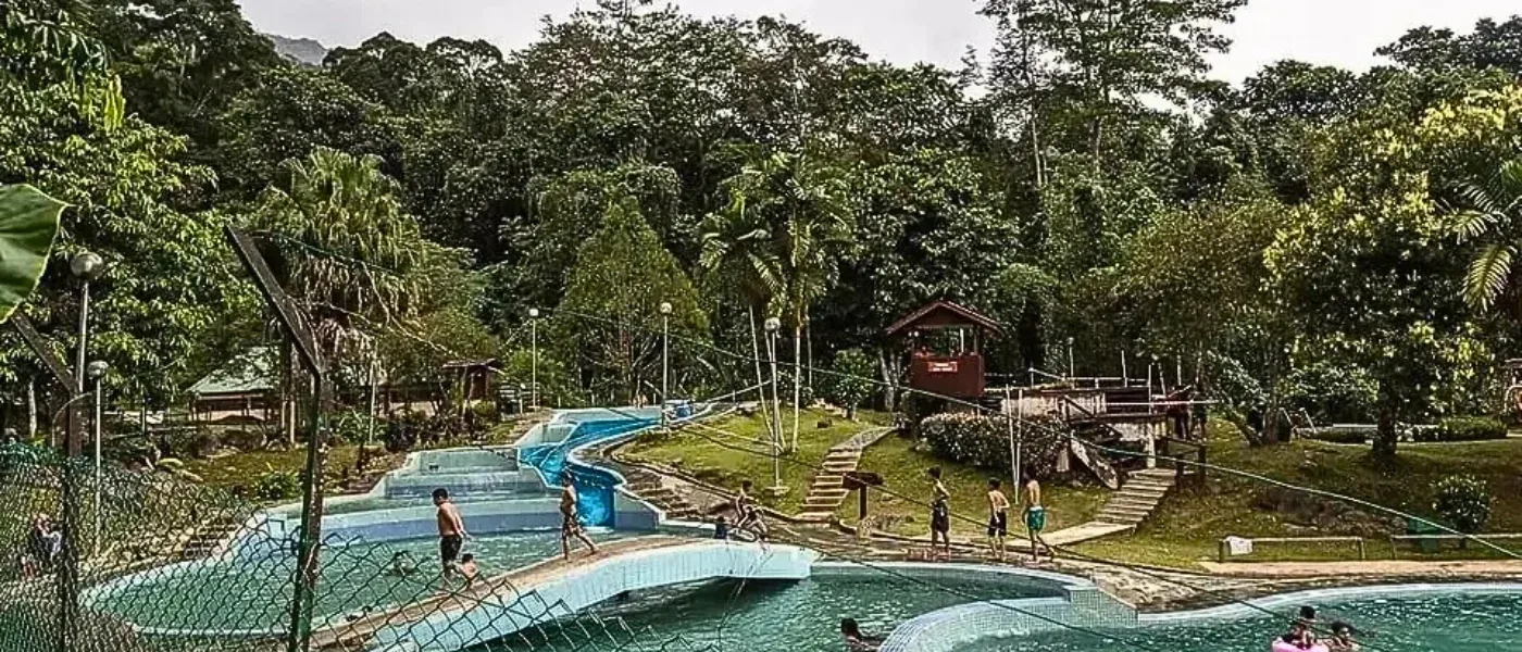 Tourists enjoying themselves in open-air bathtubs filled with natural hot spring water at Poring.